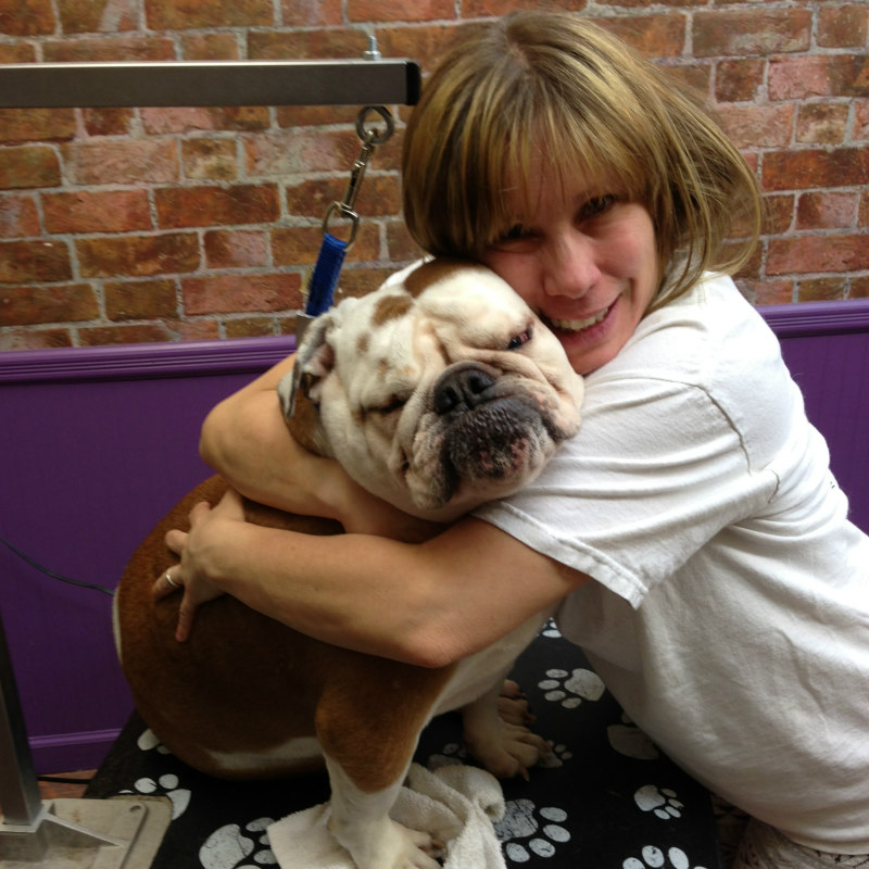 Owner Catherine Grasman hugging a Bulldog